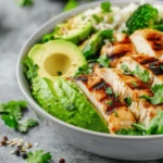 A bowl featuring a natural mounjaro recipe with 4 ingredients, including grilled chicken, broccoli, avocado, and fresh herbs.